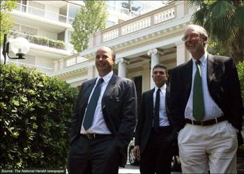 Andreas Dracopoulos, President of the Stavros Niarchos Foundation, with two other men walking outside the Great Maximos building